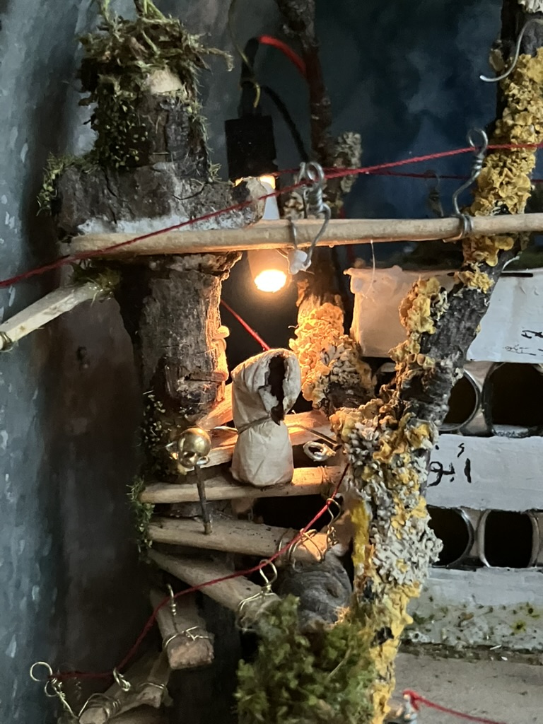 Old cigarette descends spiral stairs with a cane
