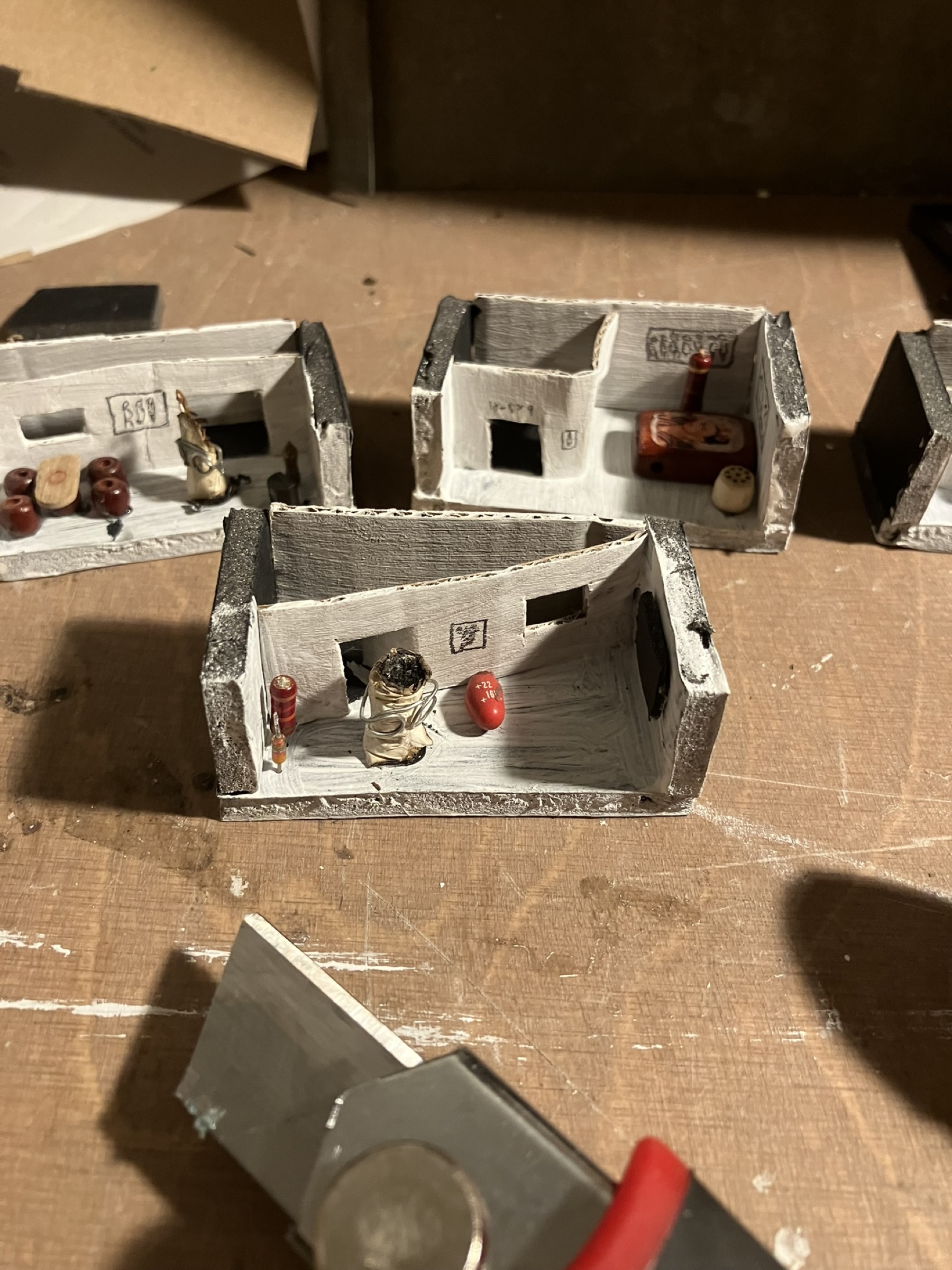 A cigarette figure living inside a miniature Kotti apartment