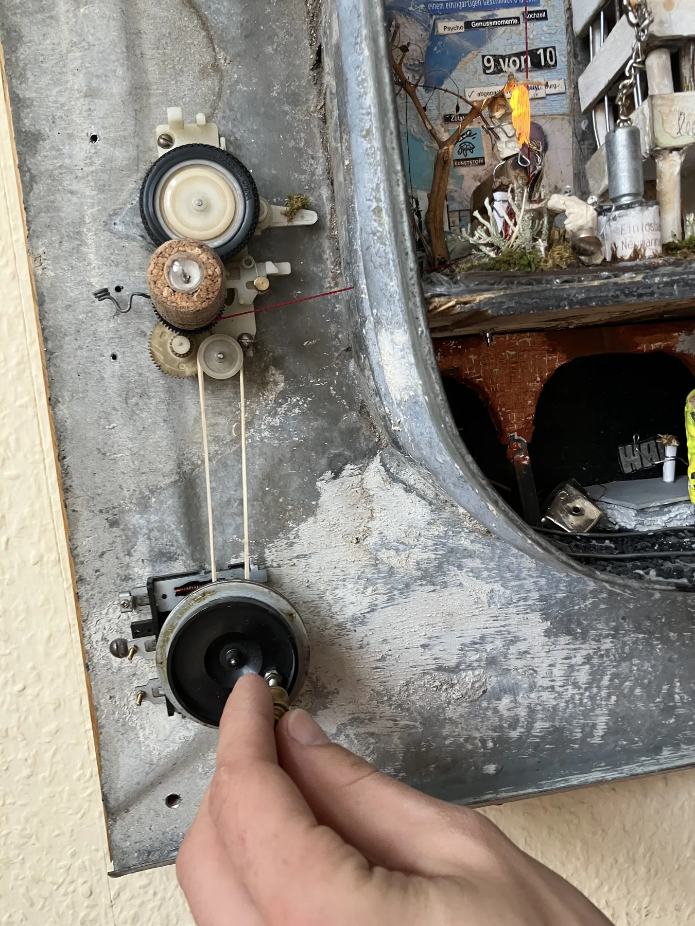 A visitor turning the external mechanical control for the miniature elevator